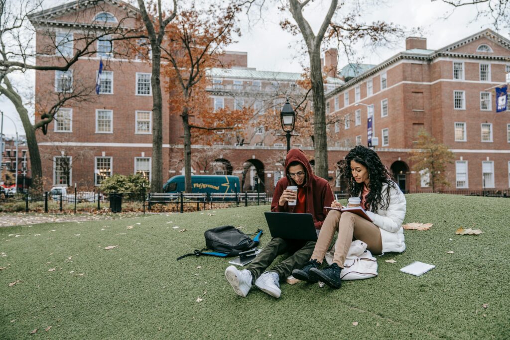 Male and female students Studying at a Park