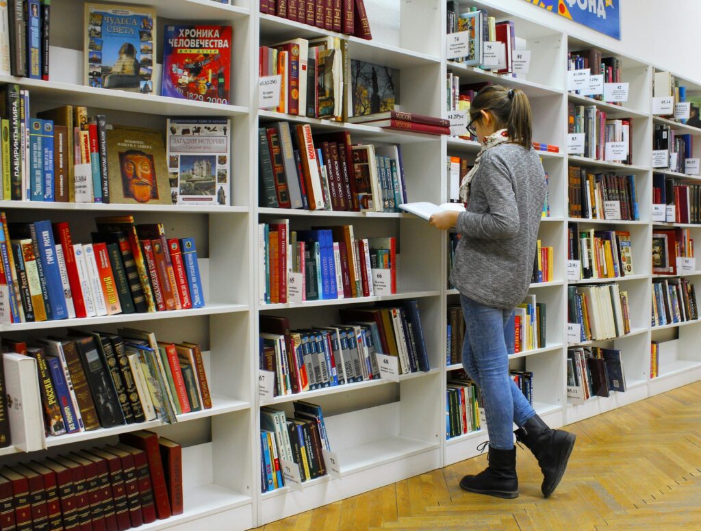 A female student Reading Book in the library alone