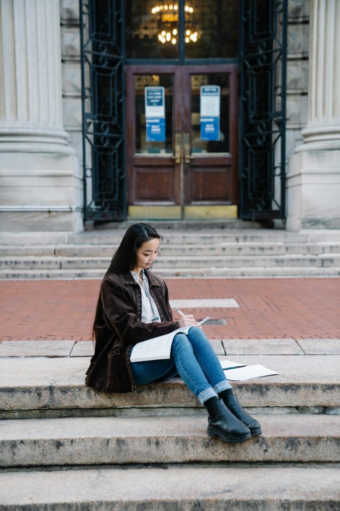 A female student Sitting on City Stairs Studying