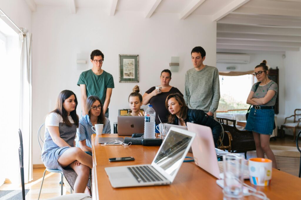 A group of students doing research on their laptops